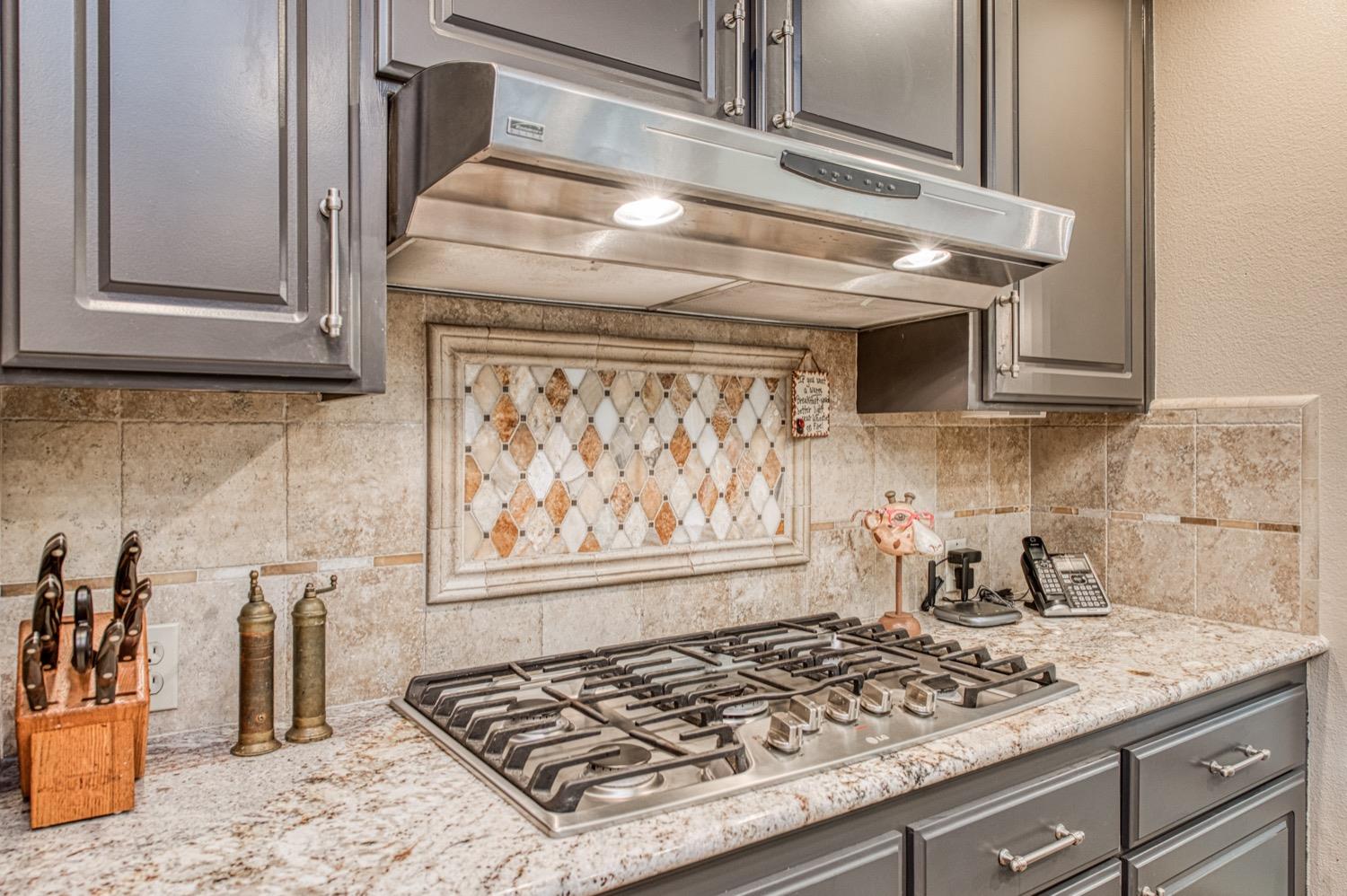 205 West Ridgepoint Drive Fresno, CA 93711 - Photo 22 of 49 a stove top oven sitting inside of a kitchen