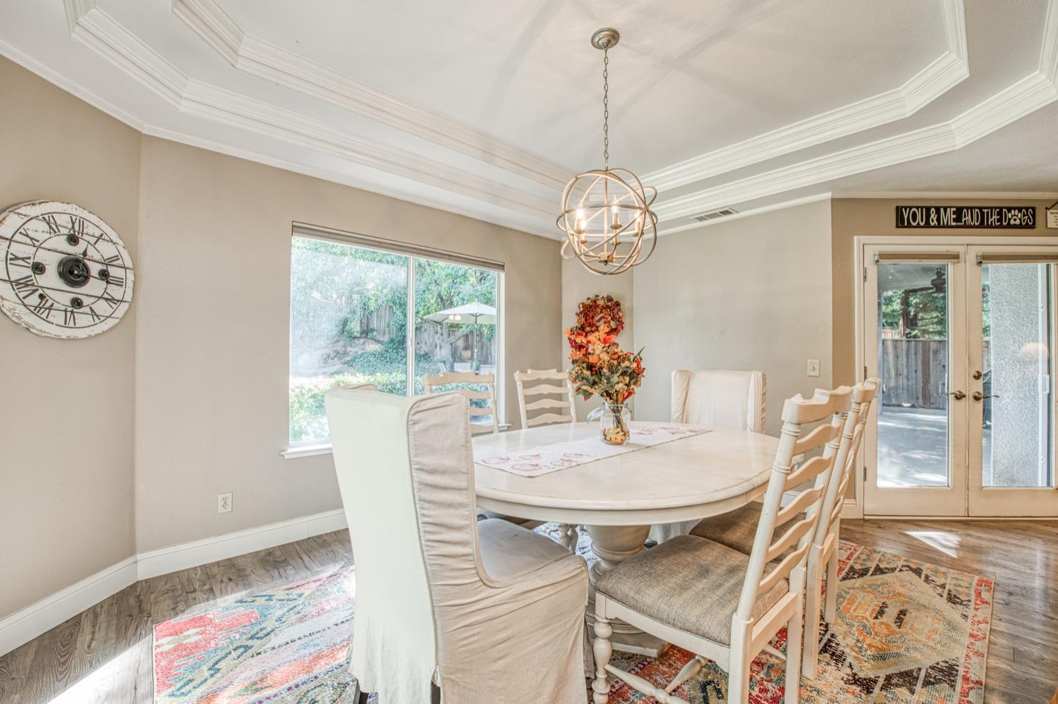 205 West Ridgepoint Drive Fresno, CA 93711 - Photo 25 of 49 a view of a dining room with furniture a chandelier and wooden floor