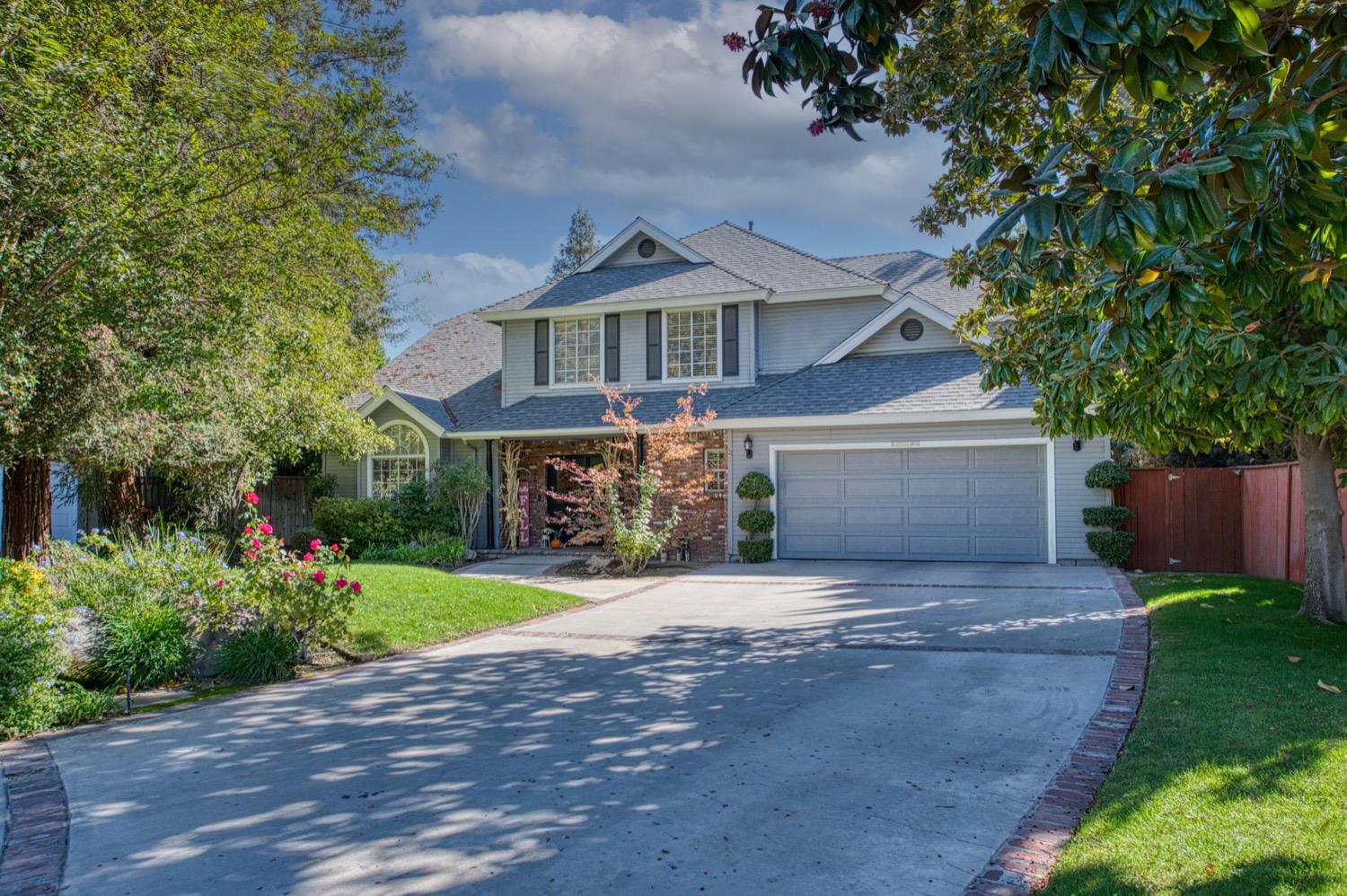205 West Ridgepoint Drive Fresno, CA 93711 - Photo 3 of 49 a front view of a house with a yard and a garage