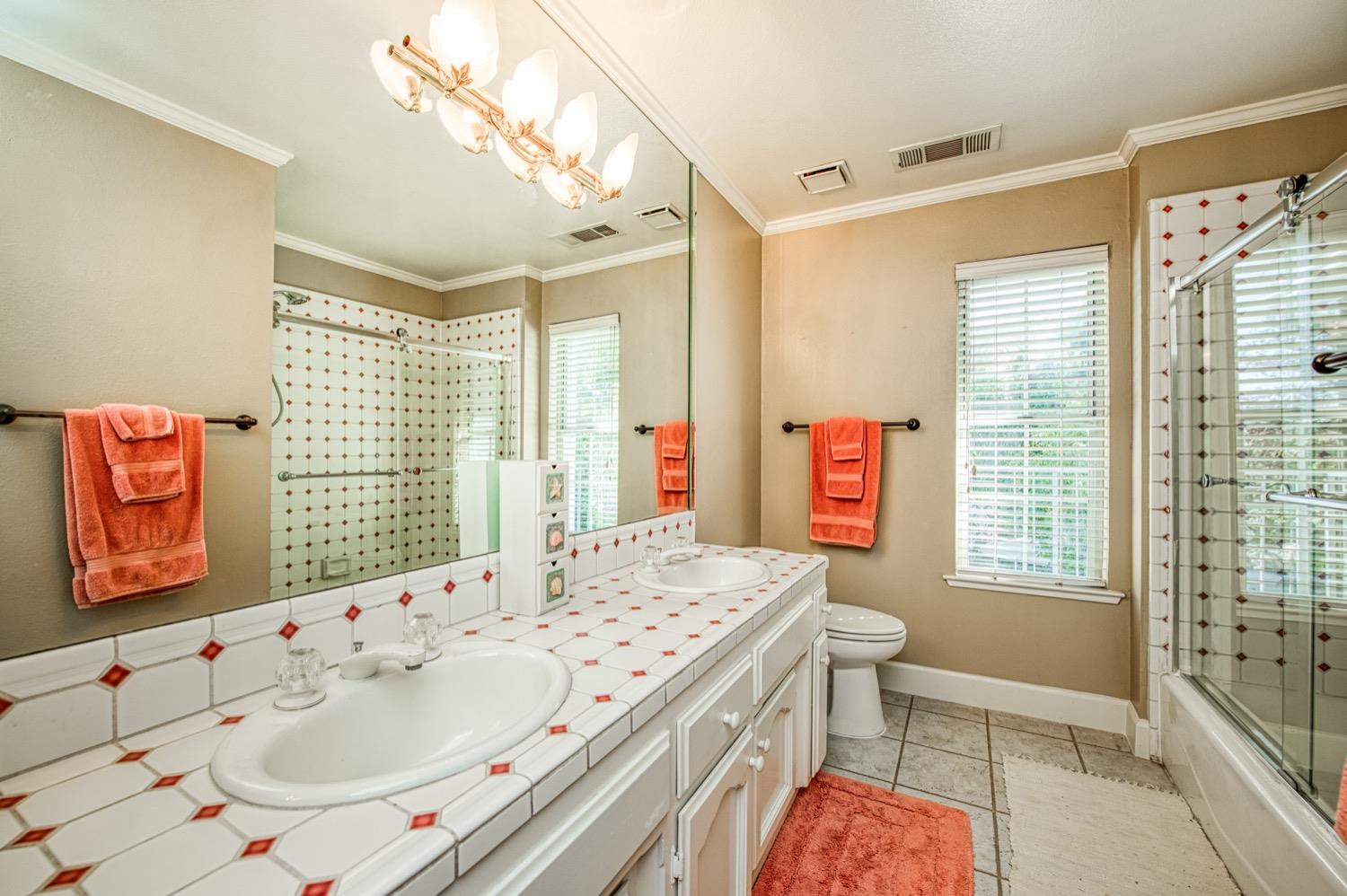 205 West Ridgepoint Drive Fresno, CA 93711 - Photo 31 of 49 a bathroom with a sink a toilet and shower
