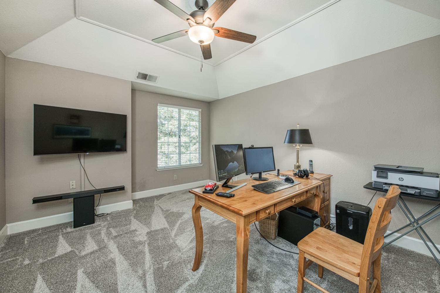 205 West Ridgepoint Drive Fresno, CA 93711 - Photo 32 of 49 a workspace with furniture and a flat screen tv