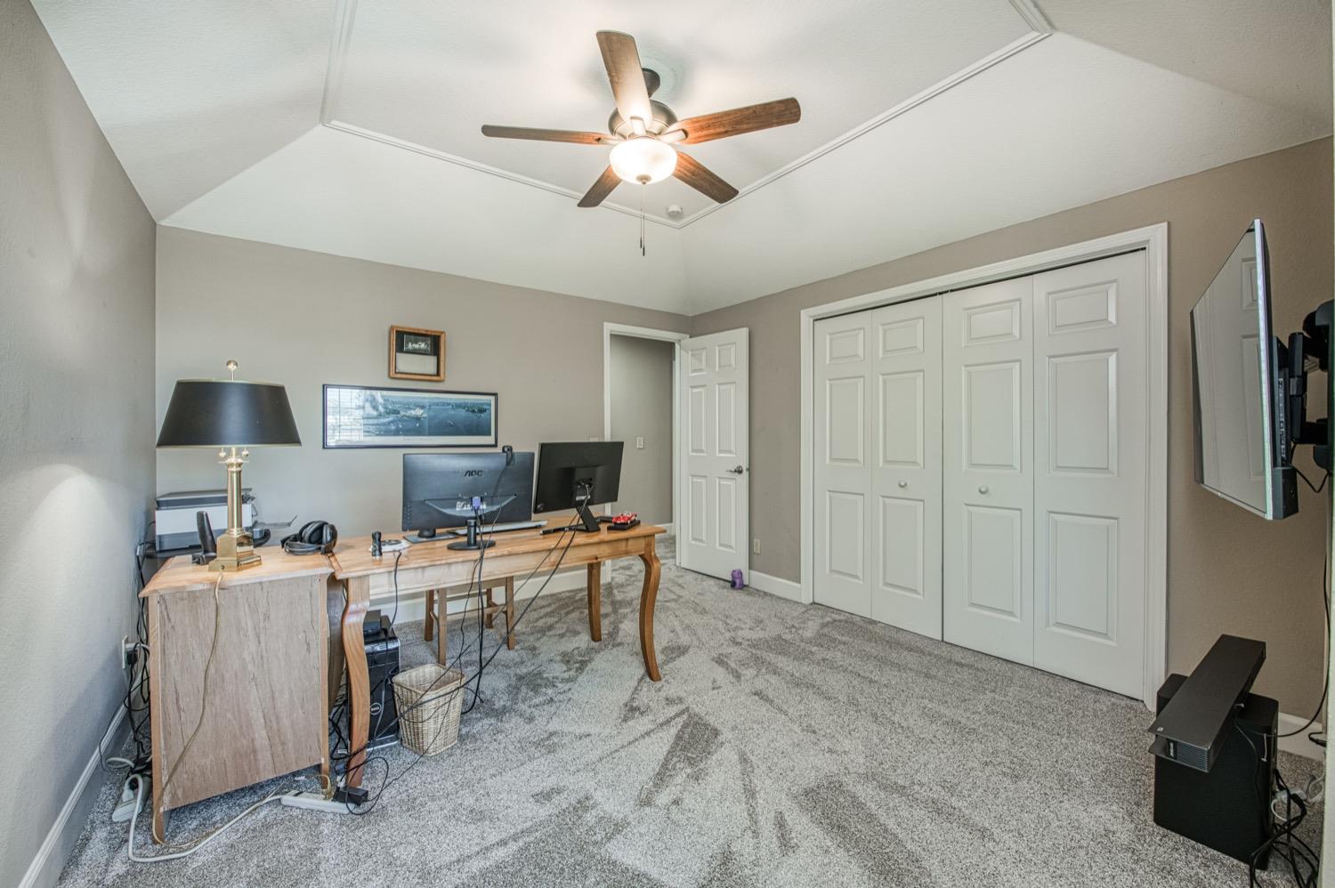 205 West Ridgepoint Drive Fresno, CA 93711 - Photo 33 of 49 a view of a workspace with furniture and a ceiling fan