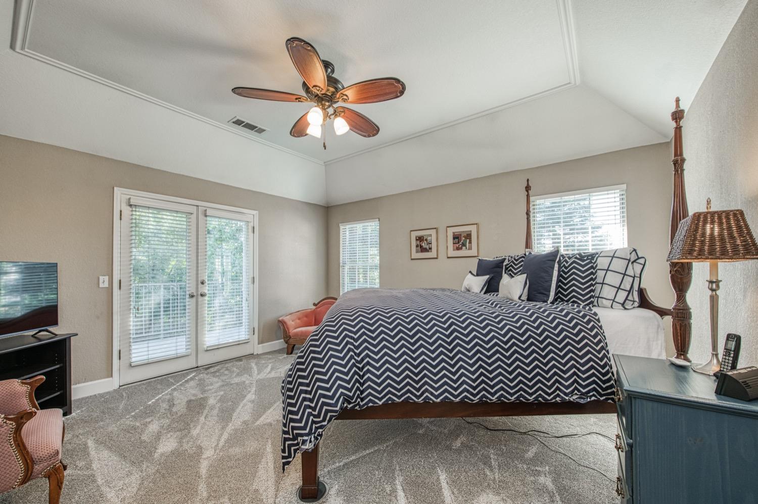 205 West Ridgepoint Drive Fresno, CA 93711 - Photo 35 of 49 a bedroom with a large bed and a chandelier