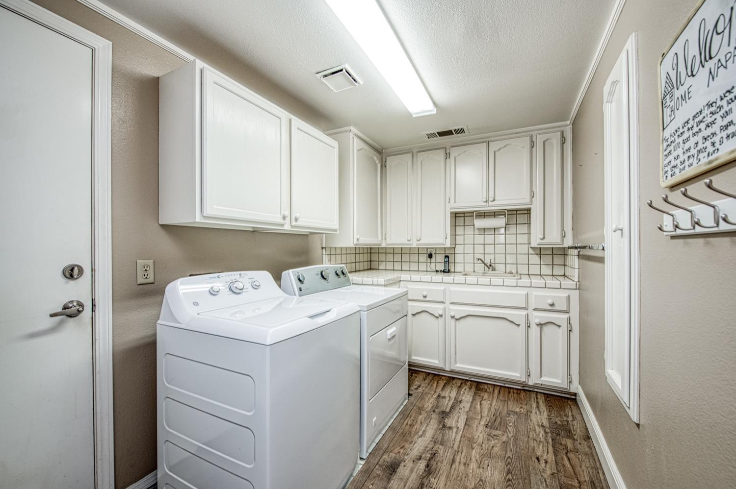 205 West Ridgepoint Drive Fresno, CA 93711 - Photo 40 of 49 a utility room with cabinets washer and dryer