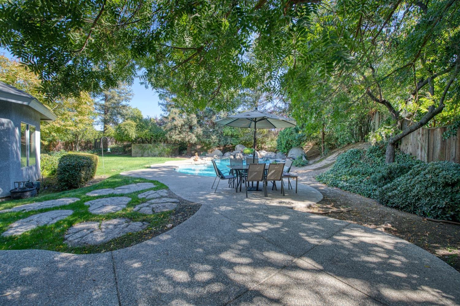 205 West Ridgepoint Drive Fresno, CA 93711 - Photo 43 of 49 a view of a patio with chairs and a yard