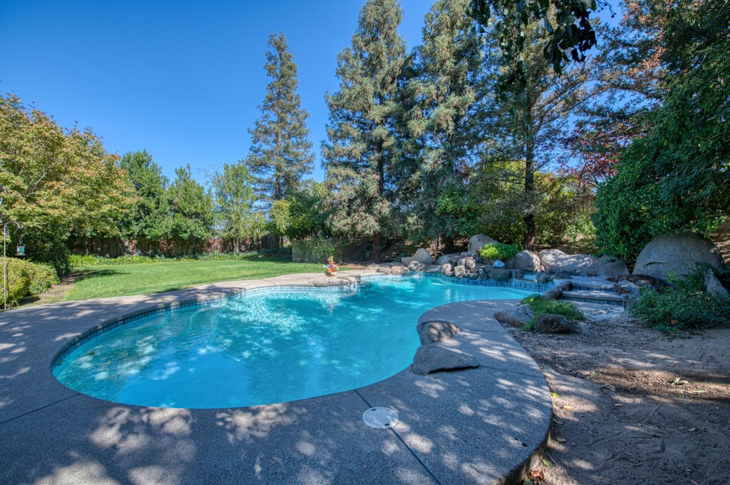 205 West Ridgepoint Drive Fresno, CA 93711 - Photo 44 of 49 a view of a swimming pool with a yard