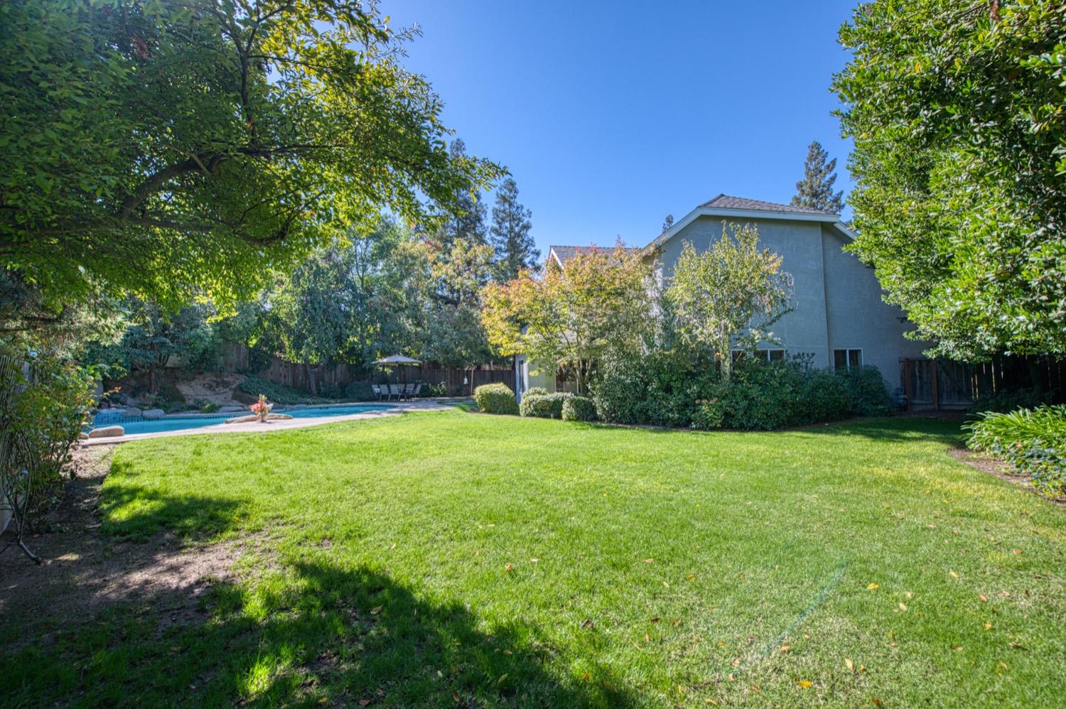 205 West Ridgepoint Drive Fresno, CA 93711 - Photo 49 of 49 a view of a yard with a house in the background