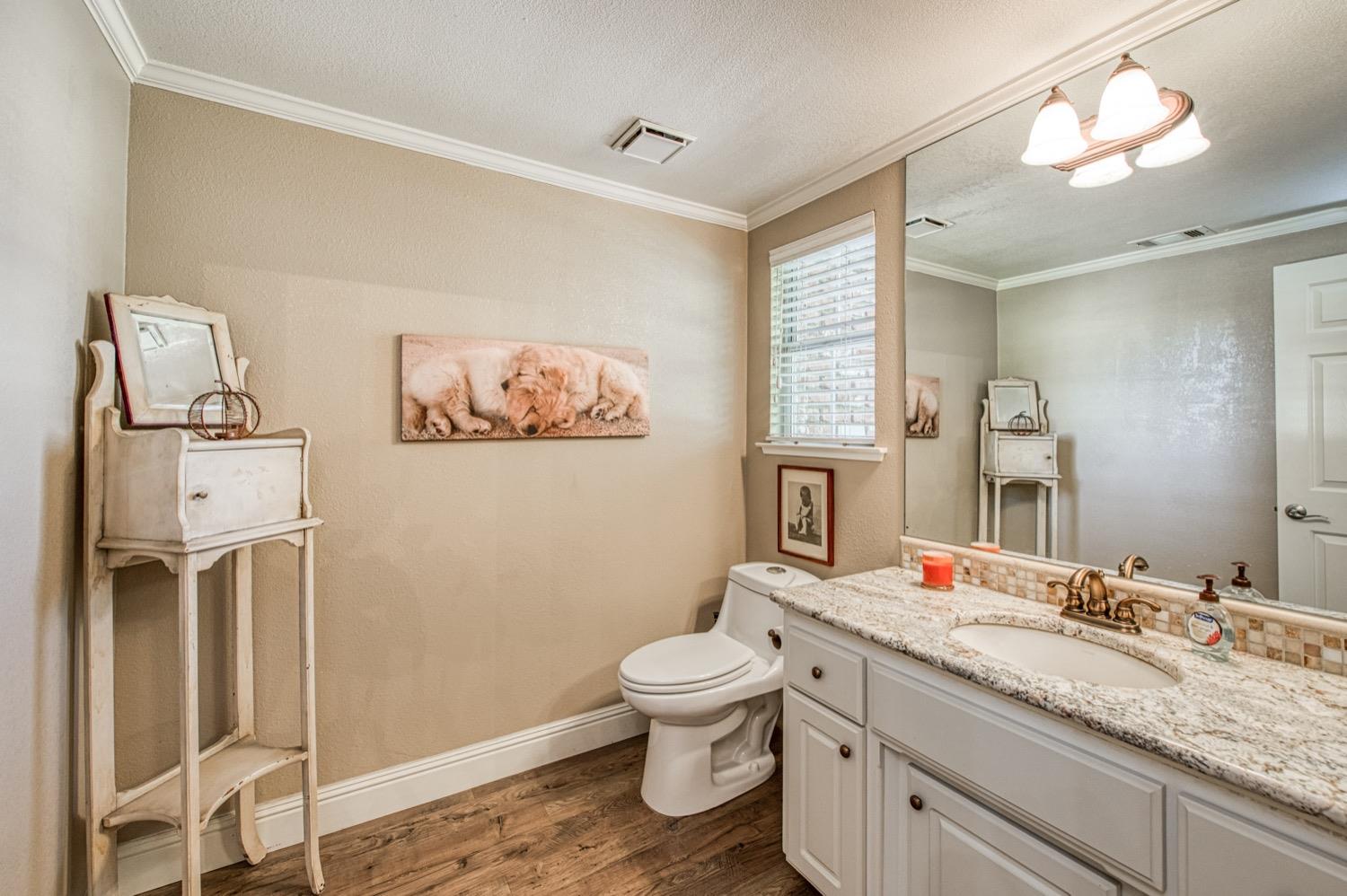 205 West Ridgepoint Drive Fresno, CA 93711 - Photo 8 of 49 a bathroom with a granite countertop sink a toilet and a mirror