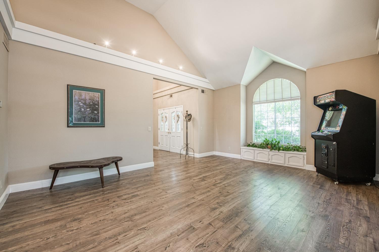 205 West Ridgepoint Drive Fresno, CA 93711 - Photo 10 of 49 a view of empty room with wooden floor and fan