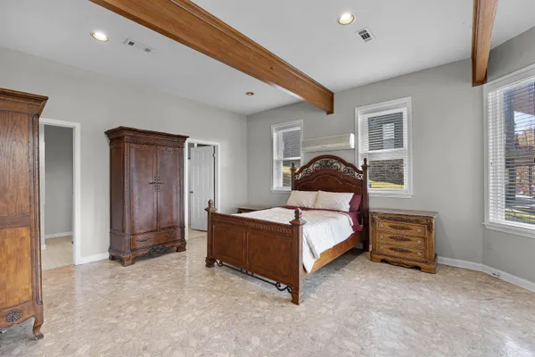 a bedroom with a bed and a window