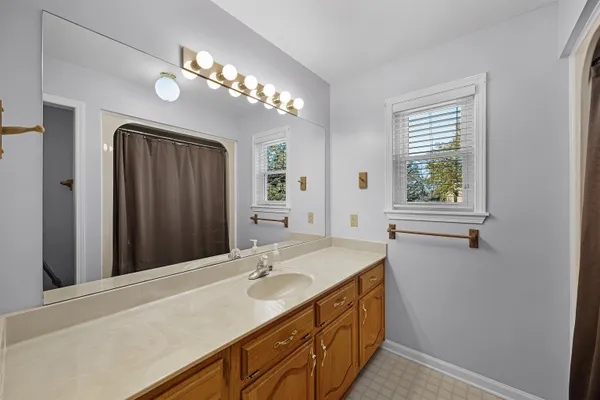 a bathroom with a sink vanity and a mirror