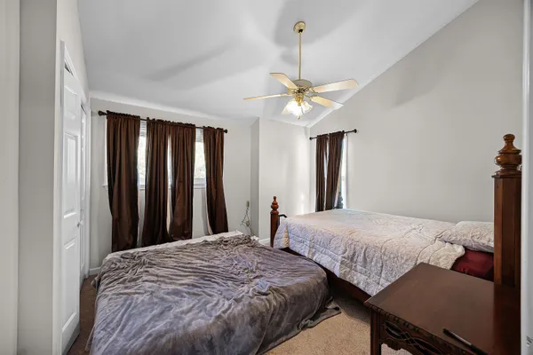 a bedroom with two beds and a chandelier