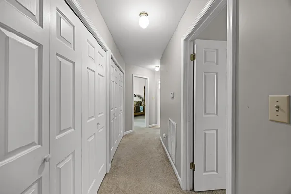 a view of a hallway with a wooden door