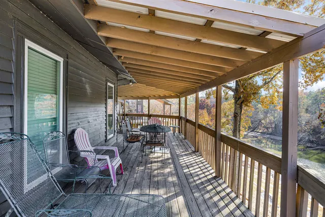 a view of a porch with furniture and wooden floor
