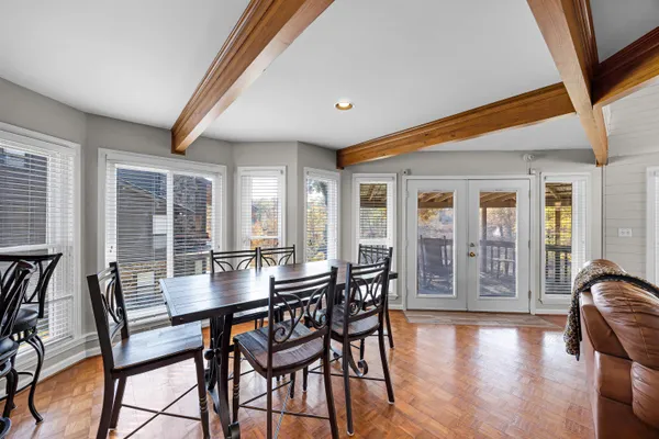 a dining room with furniture and wooden floor