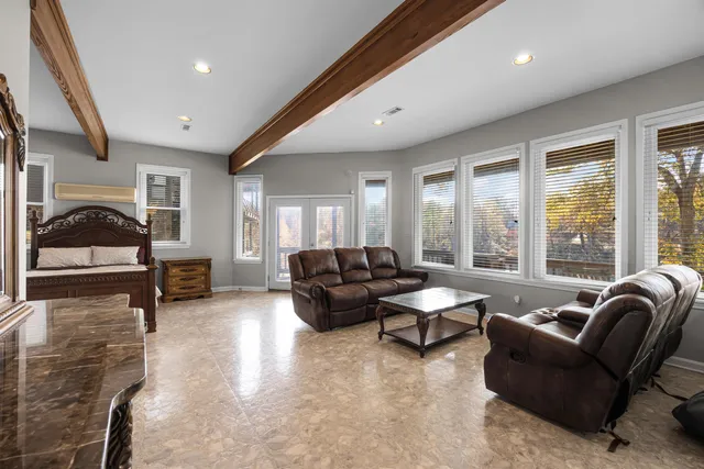 a living room with furniture and large windows