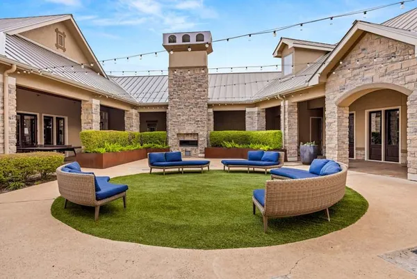 a view of a house with backyard sitting area and swimming pool