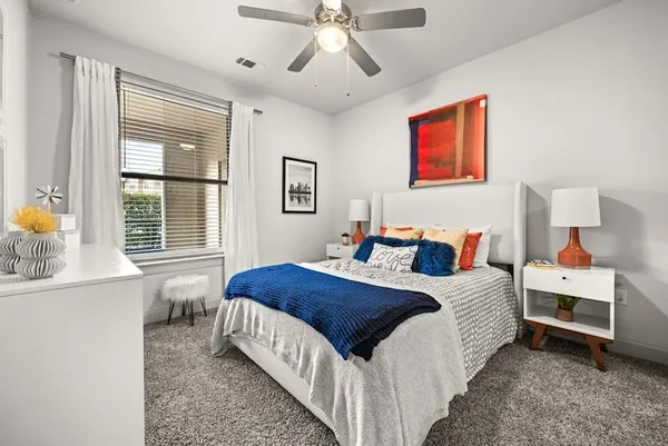 a bedroom with bed and window