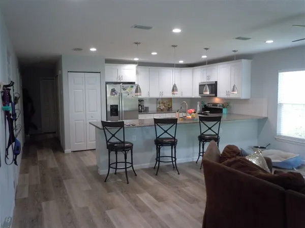 a living room with furniture and a wooden floor