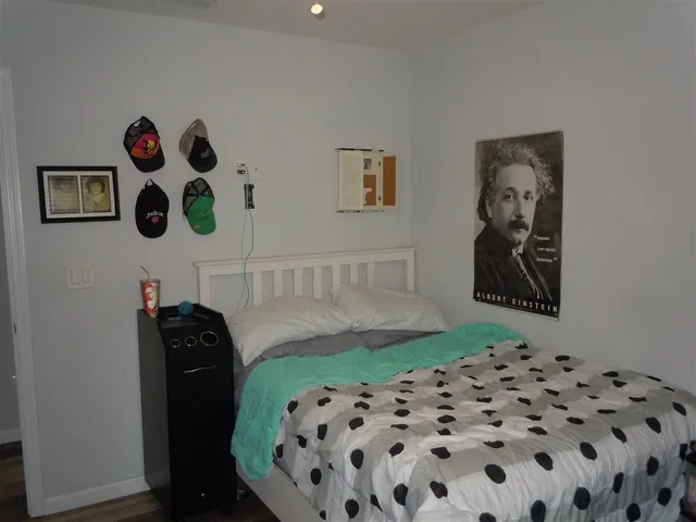a bedroom with a bed and a mirror