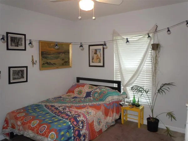 a bedroom with bed and a window