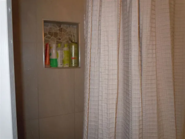 a bathroom with a shower curtain and a window