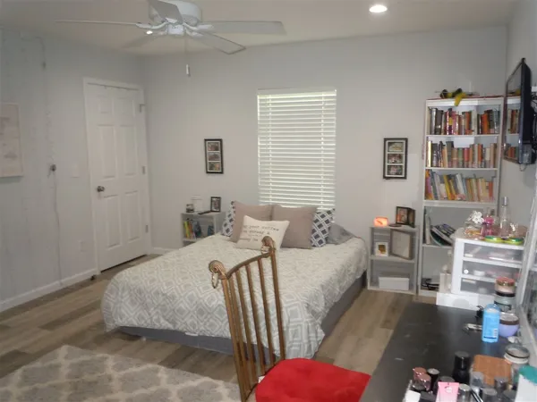 a bedroom with bed and a book shelf