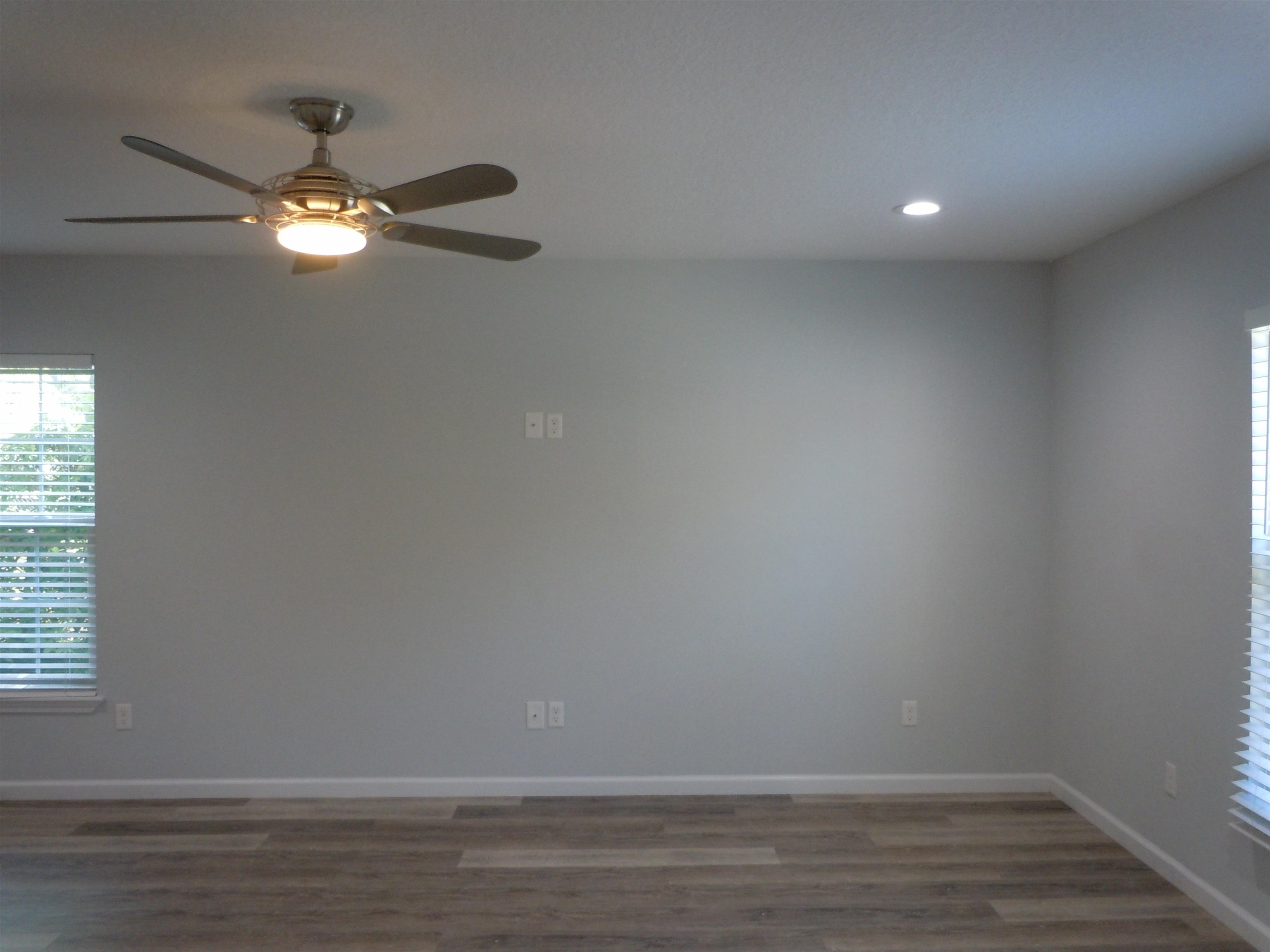 66 Julia Street St. Augustine, FL 32084 - Photo 3 of 26 a view of an empty room with wooden floor and fan