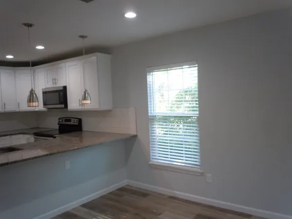 a kitchen with stainless steel appliances a microwave a sink and a microwave