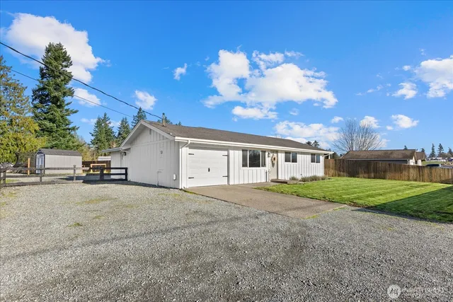 a view of a house with a yard and garage
