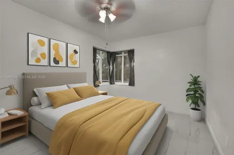 a bedroom with a bed and a potted plant