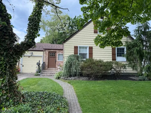 a view of a house with a yard and garden