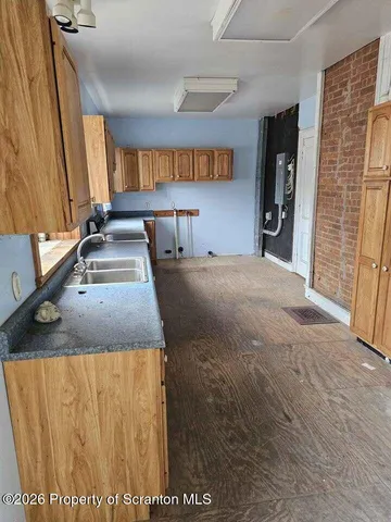 a view of a kitchen with a sink and a large window