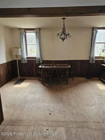a view of a room with wooden floor