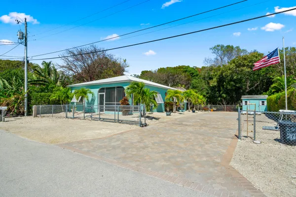 a view of a patio with a table and chairs under an umbrella
