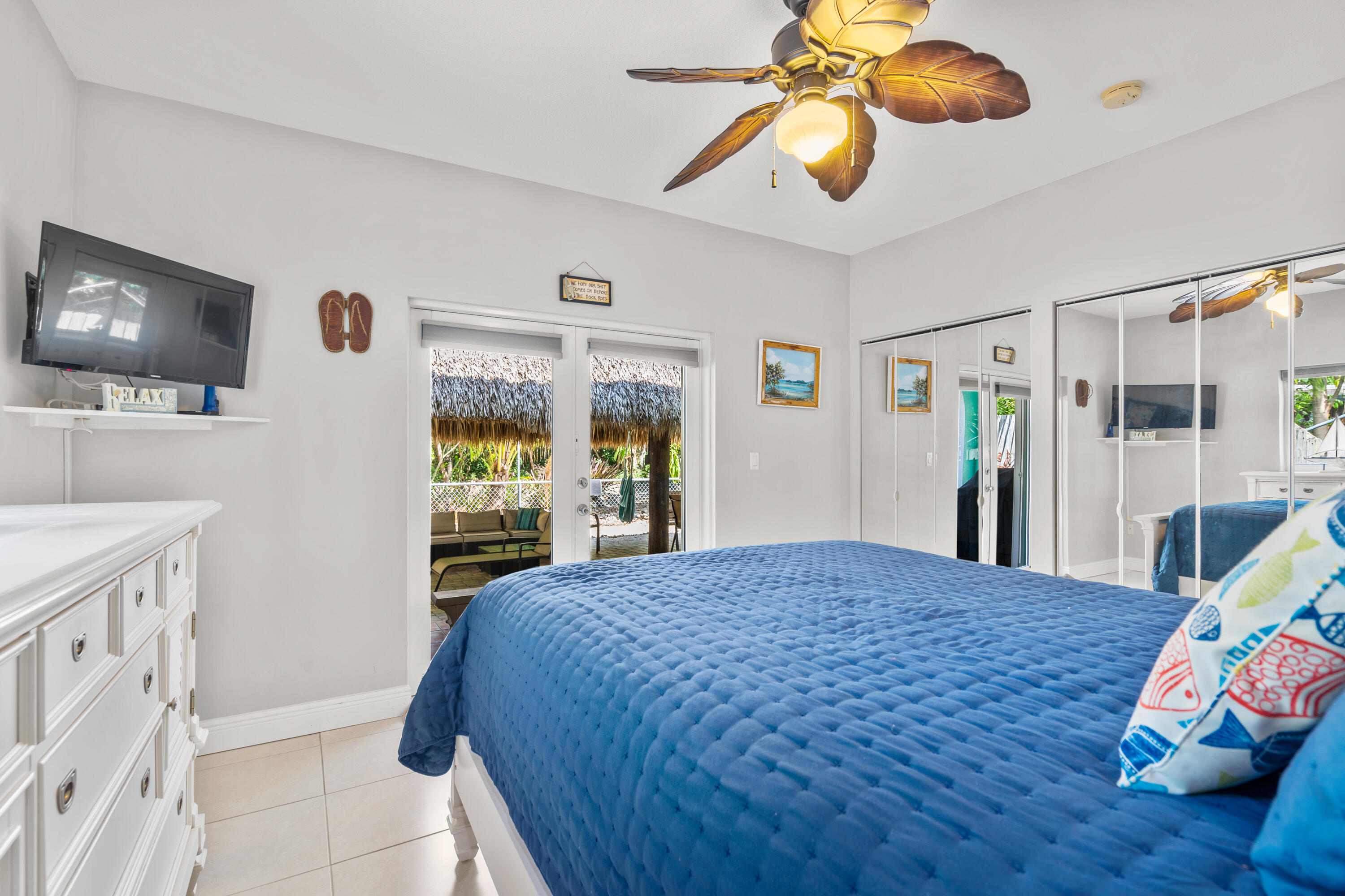 312 Ryan Avenue Key Largo, FL 33037 - Photo 18 of 47 a bedroom with a bed and a flat tv screen on dresser