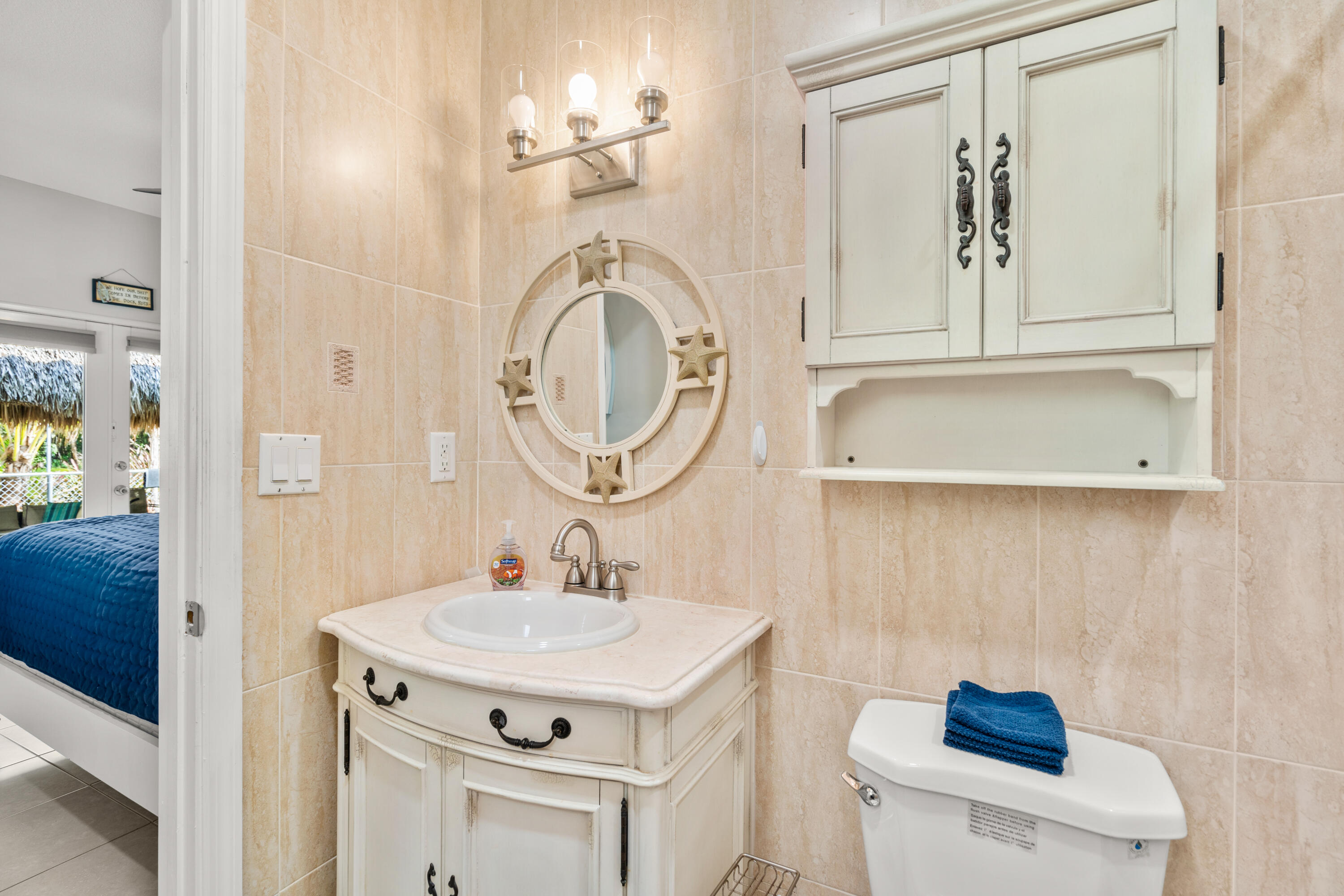 312 Ryan Avenue Key Largo, FL 33037 - Photo 20 of 47 a bathroom with a sink a toilet and a mirror