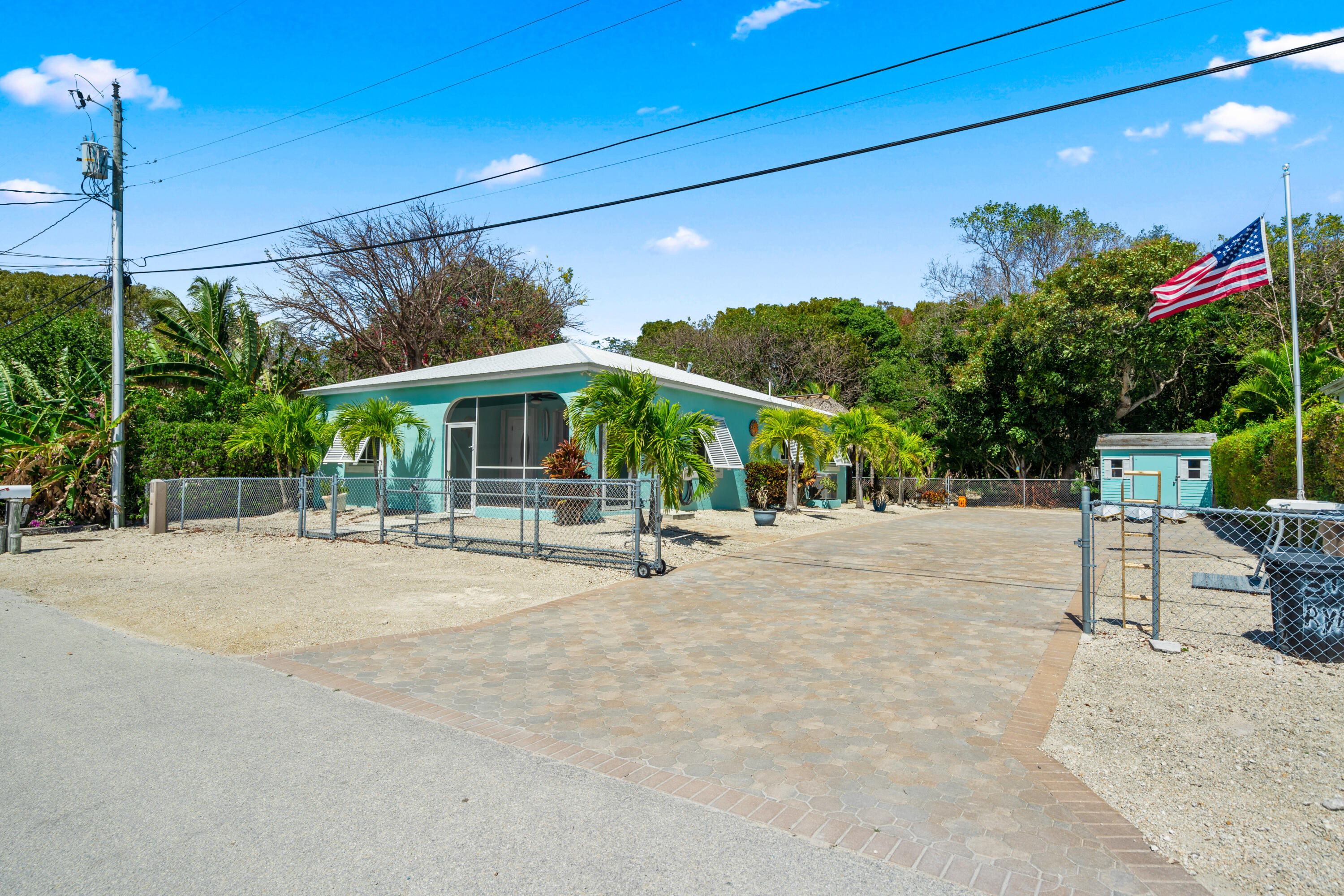 312 Ryan Avenue Key Largo, FL 33037 - Photo 2 of 47 a view of a patio with a table and chairs under an umbrella