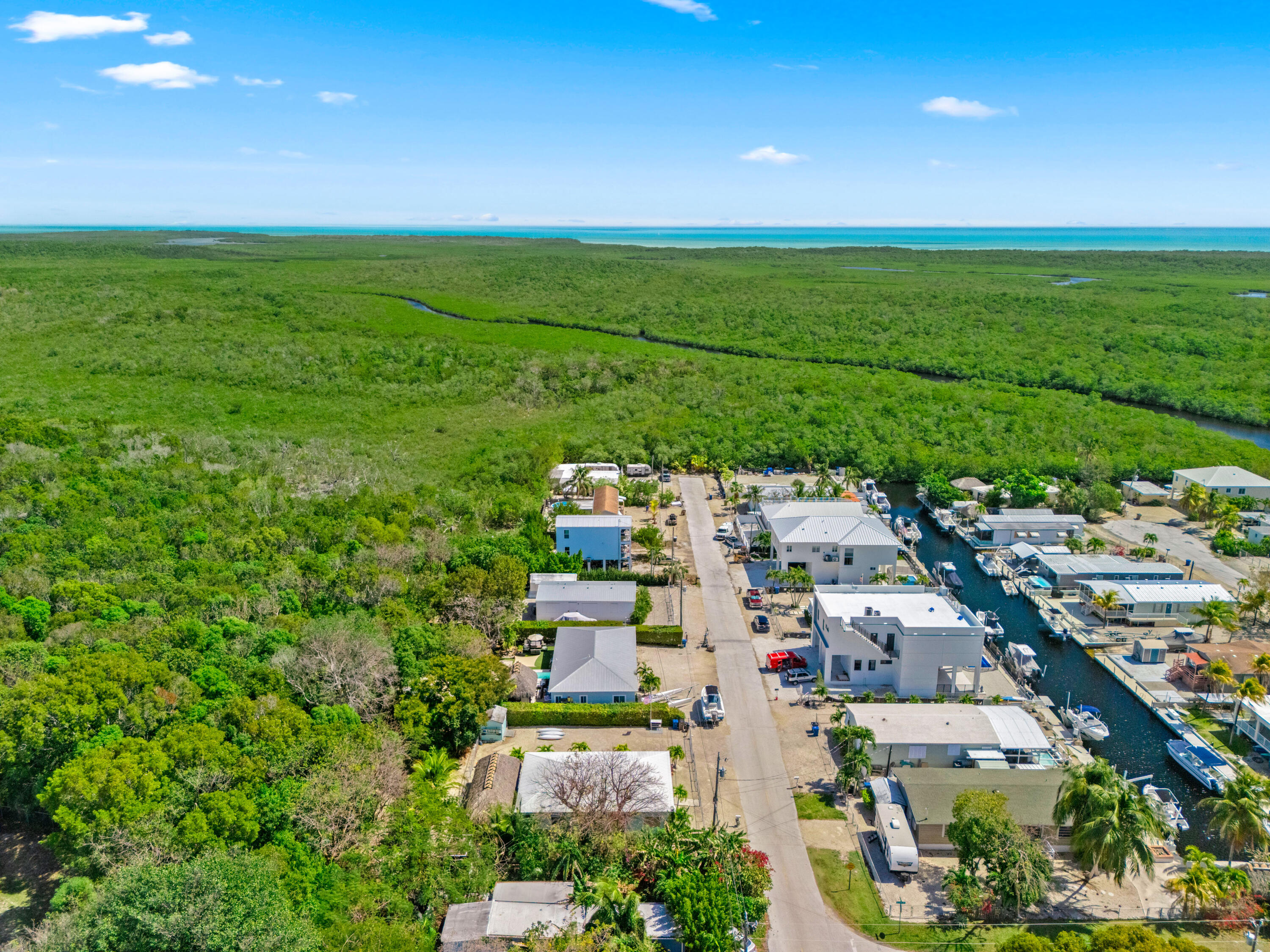 312 Ryan Avenue Key Largo, FL 33037 - Photo 44 of 47 an aerial view of a city with lots of residential buildings and mountain view in back