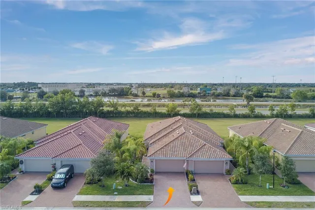 an aerial view of a house with a yard and lake view