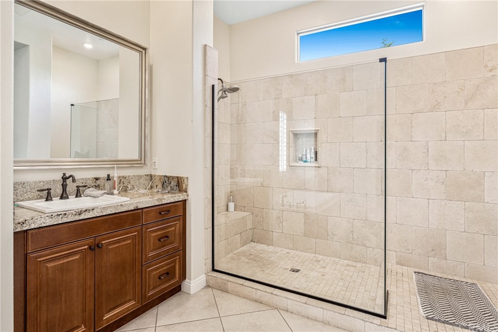 81094 Monarchos Circle La Quinta, CA 92253 - Photo 13 of 43 a bathroom with a shower sink and mirror