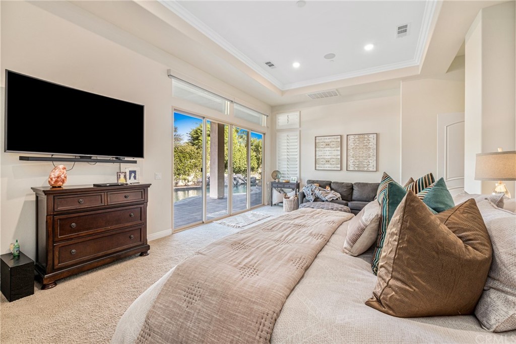 81094 Monarchos Circle La Quinta, CA 92253 - Photo 14 of 43 a spacious bedroom with a bed and a flat screen tv