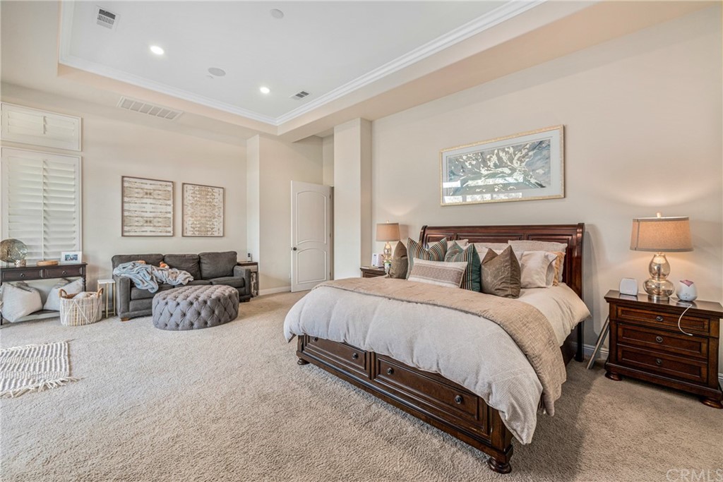 81094 Monarchos Circle La Quinta, CA 92253 - Photo 15 of 43 a spacious bedroom with a bed and couch