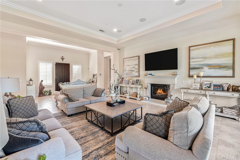 81094 Monarchos Circle La Quinta, CA 92253 - Photo 6 of 43 a living room with furniture a flat screen tv and a fireplace