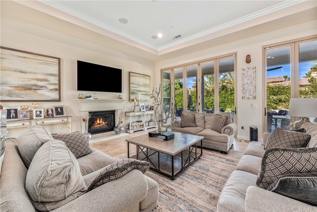 81094 Monarchos Circle La Quinta, CA 92253 - Photo 8 of 43 a living room with furniture fireplace and a flat screen tv