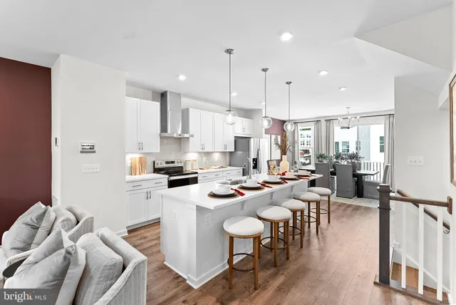 a large kitchen with a table and chairs
