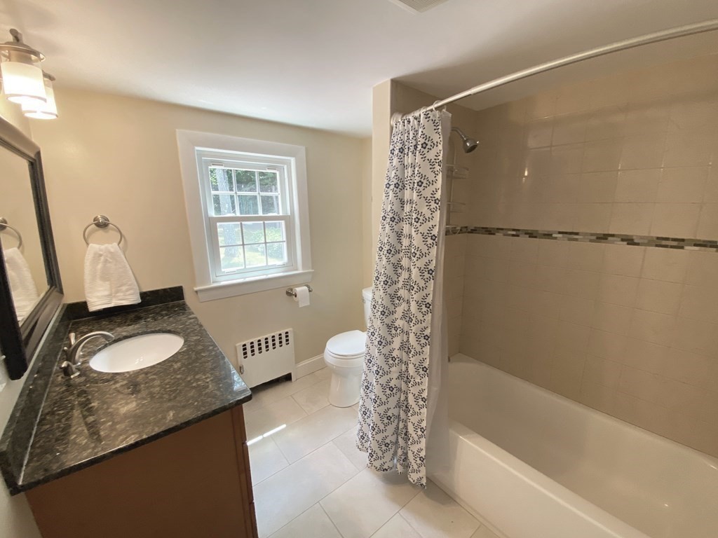 13 Pine Knoll Road Lexington, MA 02420 - Photo 16 of 24 a bathroom with a granite countertop sink and a mirror