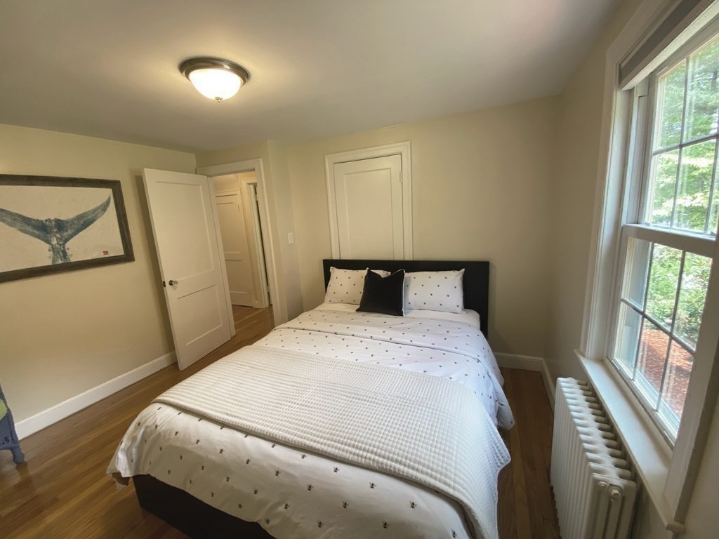 13 Pine Knoll Road Lexington, MA 02420 - Photo 18 of 24 a bed sitting in a bedroom next to a window