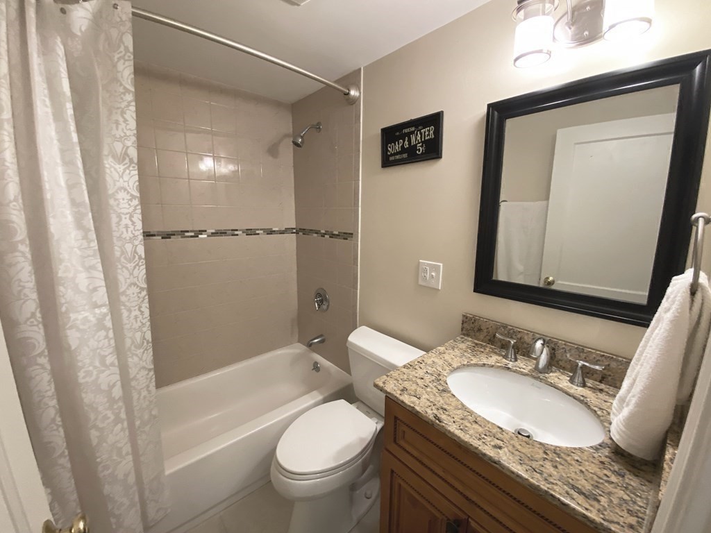 13 Pine Knoll Road Lexington, MA 02420 - Photo 20 of 24 a bathroom with a granite countertop sink toilet and shower