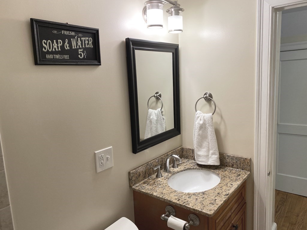 13 Pine Knoll Road Lexington, MA 02420 - Photo 21 of 24 a bathroom with a granite countertop sink and a mirror